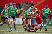 13 April 2024; Béibhinn Parsons of Ireland is tackled by Carys Phillips and Natalia John during the Women's Six Nations Rugby Championship match between Ireland and Wales at Virgin Media Park in Cork.  Photo by Brendan Moran/Sportsfile