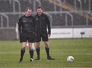 14 April 2024; Referee Seán Lonergan, left, and linesman Barry Tiernan wait in the rain for the teams to return to the pitch for the second half of the Leinster GAA Football Senior Championship quarter-final match between Kildare and Wicklow at Laois Hire O’Moore Park in Portlaoise, Laois. Photo by Piaras Ó Mídheach/Sportsfile