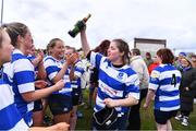14 April 2024; Clara Sexton of Athy celebrates with a bottle of champagne after their side's victory in the Cusack Plate final match between Athy and Ashbourne during the Bank of Ireland Leinster Rugby Women Finals Day at Balbriggan RFC in Dublin. Photo by Ben McShane/Sportsfile