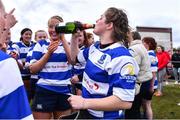 14 April 2024; Clara Sexton of Athy celebrates with a bottle of champagne after their side's victory in the Cusack Plate final match between Athy and Ashbourne during the Bank of Ireland Leinster Rugby Women Finals Day at Balbriggan RFC in Dublin. Photo by Ben McShane/Sportsfile