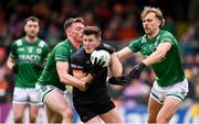 14 April 2024; Joe McElroy of Armagh in action against Oisin Smyth, left, and Ultán Kelm of Fermanagh during the Ulster GAA Football Senior Championship quarter-final match between Fermanagh and Armagh at Brewster Park in Enniskillen, Fermanagh. Photo by Ramsey Cardy/Sportsfile