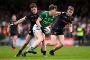 14 April 2024; Joe McDade of Fermanagh in action against Jarly Óg Burns, left, and Andrew Murnin of Armagh during the Ulster GAA Football Senior Championship quarter-final match between Fermanagh and Armagh at Brewster Park in Enniskillen, Fermanagh. Photo by Ramsey Cardy/Sportsfile