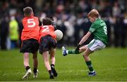 14 April 2024; Fionn Brewster, representing Fermanagh Cumann na mBunscol, grandson of Michael Brewster, who Brewster Park is named after, and son of former Fermanagh player Tom Brewster, kicks a point under pressure from Harry McAreavey, 5, and Jake Lennon, representing Armagh Cumann na mBunscolduring the Ulster GAA Football Senior Championship quarter-final match between Fermanagh and Armagh at Brewster Park in Enniskillen, Fermanagh. Photo by Ramsey Cardy/Sportsfile