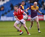14 April 2024; Conall McKeever of Louth in action against Kevin O'Grady of Wexford during the Leinster GAA Football Senior Championship quarter-final match between Louth and Wexford at Laois Hire O’Moore Park in Portlaoise, Laois. Photo by Piaras Ó Mídheach/Sportsfile