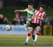 19 April 2024; Adam O'Reilly of Derry City in action against Gary O'Neill of Shamrock Rovers during the SSE Airtricity Men's Premier Division match between Derry City and Shamrock Rovers at the Ryan McBride Brandywell Stadium in Derry. Photo by Stephen McCarthy/Sportsfile
