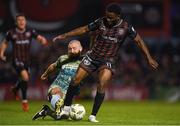 19 April 2024; James Akintunde of Bohemians is tackled by Gary Deegan of Drogheda United during the SSE Airtricity Men's Premier Division match between Bohemians and Drogheda United at Dalymount Park in Dublin. Photo by Shauna Clinton/Sportsfile