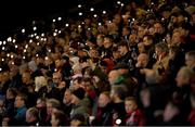 19 April 2024; Spectators raise their phone lights in remembrance of those who died in the 1981 Stardust Nightclub fire during the SSE Airtricity Men's Premier Division match between Bohemians and Drogheda United at Dalymount Park in Dublin. Photo by Shauna Clinton/Sportsfile