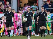 19 April 2024; Match officials, from left, assistant referee Richard Storey, referee Paul McLaughlin and assistant referee Darren Carey lead the teams out for the SSE Airtricity Men's Premier Division match between Derry City and Shamrock Rovers at the Ryan McBride Brandywell Stadium in Derry. Photo by Stephen McCarthy/Sportsfile