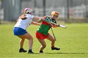 20 April 2024; Ciara Kennedy of Mayo in action against Phillipa Hughes of Cavan during the Electric Ireland All-Ireland Camogie Minor B Championship semi-final 1 match between Cavan and Mayo at Duggan Park in Ballinasloe, Galway. Photo by Sam Barnes/Sportsfile