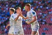 20 April 2024; Ciarán Frawley of Leinster celebrates with teammate Luke McGrath  after scoring his side's first try during the United Rugby Championship match between Emirates Lions and Leinster at Emirates Airline Park in Johannesburg, South Africa. Photo by Harry Murphy/Sportsfile