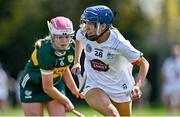 20 April 2024; Hannah Finnerty of Kildare in action against Anna Chute of Kerry during the Electric Ireland Camogie Minor B All-Ireland semi-final match between Kerry and Kildare at Banagher in Offaly. Photo by Stephen Marken/Sportsfile