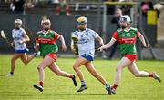 20 April 2024; Rose Geoghegan of Cavan in action against Annie McGreevey, right, and Rebekah Monaghan of Mayo during the Electric Ireland All-Ireland Camogie Minor B Championship semi-final 1 match between Cavan and Mayo at Duggan Park in Ballinasloe, Galway. Photo by Sam Barnes/Sportsfile
