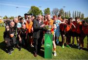 20 April 2024; St Kevin’s FC captain Logan O'Connell is presented with the cup by FAI president Paul Cooke after the FAI Youth Cup final match between St Kevin’s FC, DDSL, and Pike Rovers, Limerick District League at Home Farm FC in Dublin. Photo by Michael P Ryan/Sportsfile