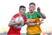 20 April 2024; Ciaran McFaul of Derry in action against Oisin Gallen of Donegal during the Ulster GAA Football Senior Championship quarter-final match between Derry and Donegal at Celtic Park in Derry. Photo by Seb Daly/Sportsfile
