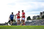 20 April 2024; Brian Hurley, centre, and Ian Maguire of Cork are consoled by team physiotherapist Brian O'Connell after the Munster GAA Football Senior Championship semi-final match between Kerry and Cork at Fitzgerald Stadium in Killarney, Kerry. Photo by Brendan Moran/Sportsfile