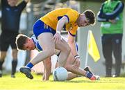 20 April 2024; Robbie McGrath of Waterford and Cillian Rouine of Clare battle for possession during the Munster GAA Football Senior Championship semi-final match between Waterford and Clare at Fraher Field in Dungarvan, Waterford. Photo by Tyler Miller/Sportsfile