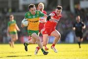 20 April 2024; Aaron Doherty of Donegal in action against Diarmuid Baker of Derry during the Ulster GAA Football Senior Championship quarter-final match between Derry and Donegal at Celtic Park in Derry. Photo by Stephen McCarthy/Sportsfile