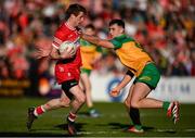 20 April 2024; Brendan Rogers of Derry in action against Michael Langan of Donegal during the Ulster GAA Football Senior Championship quarter-final match between Derry and Donegal at Celtic Park in Derry. Photo by Seb Daly/Sportsfile