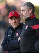20 April 2024; Derry manager Mickey Harte and selector Gavin Devlin, right, during the Ulster GAA Football Senior Championship quarter-final match between Derry and Donegal at Celtic Park in Derry. Photo by Stephen McCarthy/Sportsfile