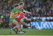 20 April 2024; Shane McGuigan of Derry in action against Daire O Baoill, left, and Jason McGee of Donegal during the Ulster GAA Football Senior Championship quarter-final match between Derry and Donegal at Celtic Park in Derry. Photo by Stephen McCarthy/Sportsfile