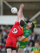 20 April 2024; Caolan McGonagle of Donegal in action against Brendan Rogers of Derry during the Ulster GAA Football Senior Championship quarter-final match between Derry and Donegal at Celtic Park in Derry. Photo by Stephen McCarthy/Sportsfile