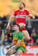 20 April 2024; Conor Glass of Derry in action against Caolan McGonagle of Donegal during the Ulster GAA Football Senior Championship quarter-final match between Derry and Donegal at Celtic Park in Derry. Photo by Stephen McCarthy/Sportsfile