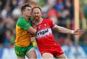 20 April 2024; Conor Glass of Derry in action against Peadar Mogan of Donegal during the Ulster GAA Football Senior Championship quarter-final match between Derry and Donegal at Celtic Park in Derry. Photo by Stephen McCarthy/Sportsfile