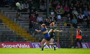 20 April 2024; Louise Ní Mhuircheartaigh of Kerry scores her side's first goal despite the efforts of Emma Cronin of Tipperary during the Munster LGFA Senior Championship round 1 between Kerry and Tipperary at Fitzgerald Stadium in Killarney, Kerry. Photo by Brendan Moran/Sportsfile