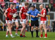20 April 2024; Ruairi Deane and Brian O'Driscoll of Cork speak to referee Noel Mooney about remaining time after winning a late free kick during the Munster GAA Football Senior Championship semi-final match between Kerry and Cork at Fitzgerald Stadium in Killarney, Kerry. Photo by Brendan Moran/Sportsfile