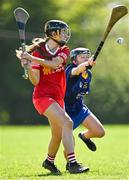 21 April 2024; Orlaith McElduff of Tyrone in action against Ciara Lambe of Wicklow during the Electric Ireland All-Ireland Camogie Minor C semi-final match between Tyrone and Wicklow at Dunganny in Meath. Photo by Sam Barnes/Sportsfile