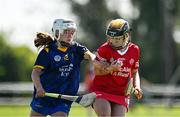 21 April 2024; Niamh McElduff of Tyrone  in action against Aishing O'Toole of Wicklow during the Electric Ireland All-Ireland Camogie Minor C semi-final match between Tyrone and Wicklow at Dunganny in Meath. Photo by Sam Barnes/Sportsfile