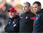 20 April 2024; Derry manager Mickey Harte, left, with selector Gavin Devlin and selector Paul McFlynn, right, during the Ulster GAA Football Senior Championship quarter-final match between Derry and Donegal at Celtic Park in Derry. Photo by Stephen McCarthy/Sportsfile