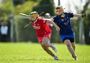 21 April 2024; Eva Cullen of Tyrone in action against Cara Mahony of Wicklow during the Electric Ireland All-Ireland Camogie Minor C semi-final match between Tyrone and Wicklow at Dunganny in Meath. Photo by Sam Barnes/Sportsfile