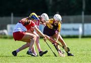 21 April 2024; Robyn Kinsella of Wexford in action against Paige Bell, left, and Grace Draine of Derry during the Electric Ireland All-Ireland Camogie Minor A Shield semi-final match between Derry and Wexford at Clane in Kildare. Photo by Daire Brennan/Sportsfile
