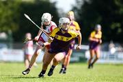 21 April 2024; Karen Hayden of Wexford in action against Grace Draine of Derry during the Electric Ireland All-Ireland Camogie Minor A Shield semi-final match between Derry and Wexford at Clane in Kildare. Photo by Daire Brennan/Sportsfile