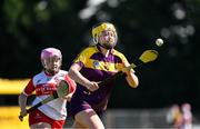 21 April 2024; Katie Bolger of Wexford in action against Natalie McKenna of Derry during the Electric Ireland All-Ireland Camogie Minor A Shield semi-final match between Derry and Wexford at Clane in Kildare. Photo by Daire Brennan/Sportsfile