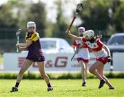 21 April 2024; Abbie Doyle of Wexford in action against Grace Draine of Derry during the Electric Ireland All-Ireland Camogie Minor A Shield semi-final match between Derry and Wexford at Clane in Kildare. Photo by Daire Brennan/Sportsfile