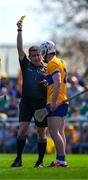 21 April 2024; Adam Hogan of Clare is shown a yellow card by referee Colm Lyons during the Munster GAA Hurling Senior Championship Round 1 match between Clare and Limerick at Cusack Park in Ennis, Clare. Photo by Ray McManus/Sportsfile