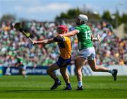 21 April 2024; John Conlon of Clare is tackled by Aaron Gillane of Limerick during the Munster GAA Hurling Senior Championship Round 1 match between Clare and Limerick at Cusack Park in Ennis, Clare. Photo by Ray McManus/Sportsfile