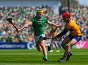 21 April 2024; John Conlon of Clare clears under pressure from Cathal O Neill of Limerick during the Munster GAA Hurling Senior Championship Round 1 match between Clare and Limerick at Cusack Park in Ennis, Clare. Photo by Ray McManus/Sportsfile