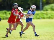 21 April 2024; Hannah McGrath of Waterford is tackled by Ava Fitzgerald of Cork during the Electric Ireland All-Ireland Camogie Minor A semi-final match between Cork and Waterford at Kilcommon in Tipperary. Photo by Tom Beary/Sportsfile