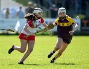 21 April 2024; Lucy McKaigue of Derry in action against Abbie Doyle of Wexford during the Electric Ireland All-Ireland Camogie Minor A Shield semi-final match between Derry and Wexford at Clane in Kildare. Photo by Daire Brennan/Sportsfile