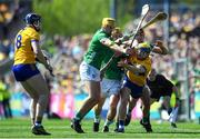 21 April 2024;Seadna Morey of Clare is tackled by Limerick players, from left, Cathal O Neill, Tom Morrissey and Barry Nash during the Munster GAA Hurling Senior Championship Round 1 match between Clare and Limerick at Cusack Park in Ennis, Clare. Photo by John Sheridan/Sportsfile