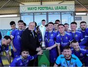 21 April 2024; Waterford & District Junior Football League captain Adam Conway is presented with the trophy by FAI Director of Competitions Fran Gavin after the FAI Oscar Traynor Inter-League Cup final match between Mayo Football League and Waterford & District Junior League at Umbro Park, Milebush, Castlebar in Mayo. Photo by Michael P Ryan/Sportsfile