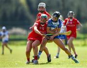 21 April 2024; Amy McCarthy of Cork is tackled by Maggie Gostl of Waterford during the Electric Ireland All-Ireland Camogie Minor A semi-final match between Cork and Waterford at Kilcommon in Tipperary. Photo by Tom Beary/Sportsfile