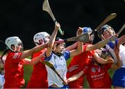 21 April 2024; Maggie Gostl of Waterford competes for a high ball with Cork players, from left, Keeley Goulding, Sinéad Hurley, Sarah Murphy and Saoirse Cunningham, during the Electric Ireland All-Ireland Camogie Minor A semi-final match between Cork and Waterford at Kilcommon in Tipperary. Photo by Tom Beary/Sportsfile
