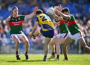 21 April 2024; Ben O'Carroll of Roscommon has a shot blocked down by Tommy Conroy of Mayo, right, during the Connacht GAA Football Senior Championship semi-final match between Roscommon and Mayo at Dr Hyde Park in Roscommon. Photo by Piaras Ó Mídheach/Sportsfile