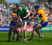 21 April 2024; Will O Donoghue of Limerick is tackled by Seadna Morey, left, and David Fitzgerald of Clare during the Munster GAA Hurling Senior Championship Round 1 match between Clare and Limerick at Cusack Park in Ennis, Clare. Photo by Ray McManus/Sportsfile