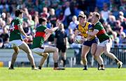 21 April 2024; Diarmuid Murtagh of Roscommon in action against Mayo players, from left, Tommy Conroy, Sam Callinan and Ryan O'Donoghue during the Connacht GAA Football Senior Championship semi-final match between Roscommon and Mayo at Dr Hyde Park in Roscommon. Photo by Piaras Ó Mídheach/Sportsfile