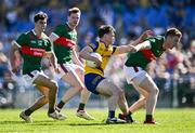 21 April 2024; Ben O'Carroll of Roscommon in action against Mayo players, from left, Tommy Conroy, Matthew Ruane and David McBrien during the Connacht GAA Football Senior Championship semi-final match between Roscommon and Mayo at Dr Hyde Park in Roscommon. Photo by Piaras Ó Mídheach/Sportsfile
